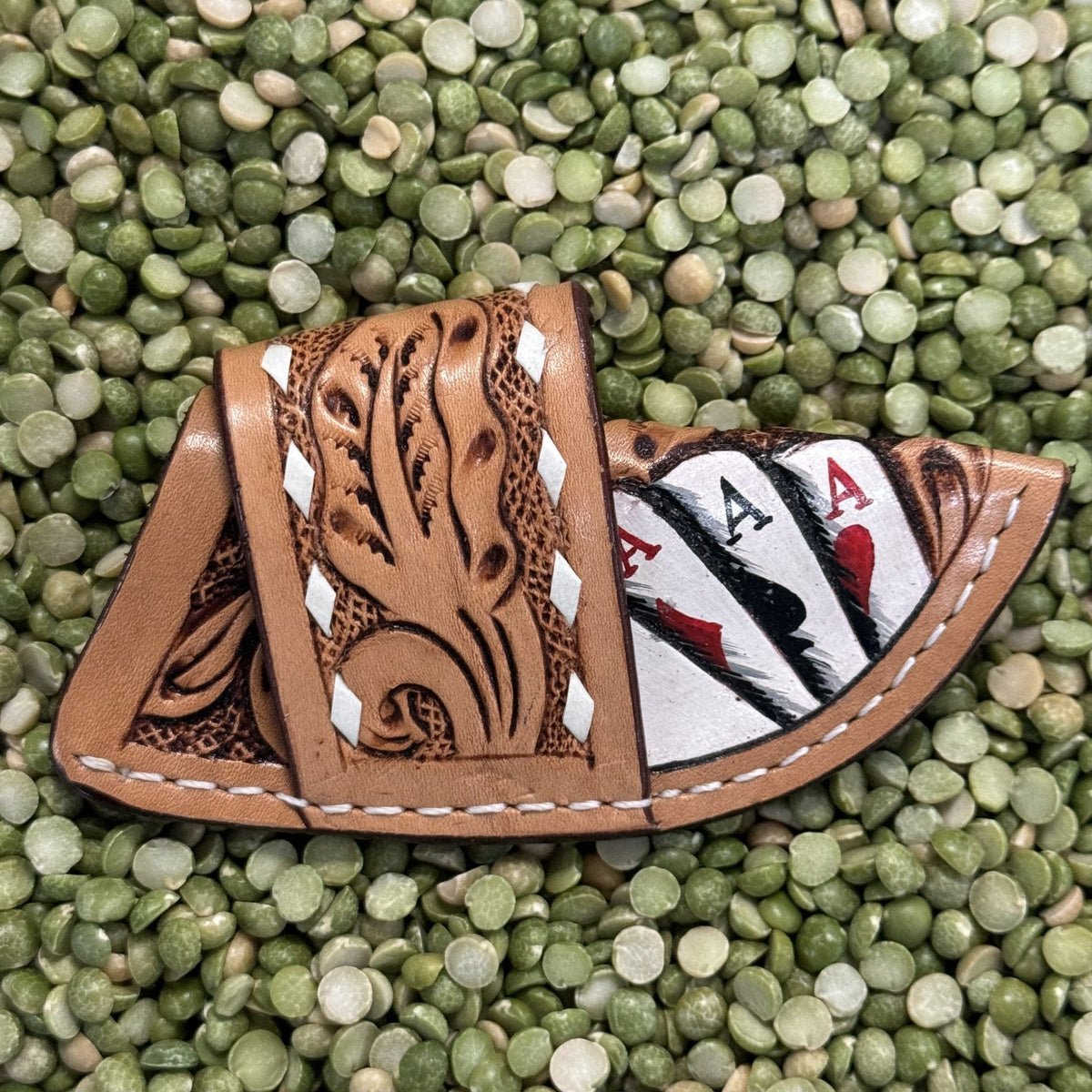 Leather Sheath Tan Ace of Spades Knife Sheath in brown and white, hand-tooled floral detailing with painted ace card design, with decorative lacing for style and durability - 29RS68C. Available at Blair's Western Wear, Marble Falls, TX.