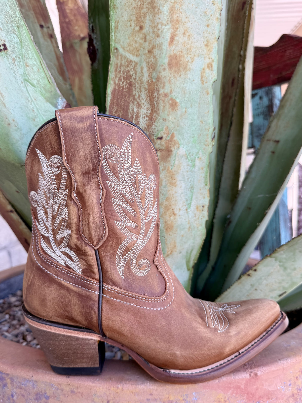 Brown Western bootie with cream leaf-and-scroll embroidery, pull tab, dark piping and tapered toe — Blair's Western Wear Marble Falls TX