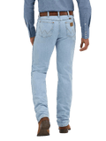 Men's bleach wash slim fit cowboy cut jean back view with iconic W-stitch pockets and Wrangler leather patch, styled with western shirt and boots — Blair's Western Wear Marble Falls TX