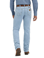 Men's bleach wash slim fit cowboy cut jean back view with iconic W-stitch pockets and Wrangler leather patch, styled with western shirt and boots — Blair's Western Wear Marble Falls TX