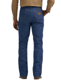 Rear view of a person wearing blue denim jeans with a tan long-sleeve button-up shirt and brown shoes, shown against a plain white background.