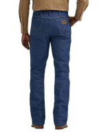 Rear view of a person wearing blue denim jeans with a tan long-sleeve button-up shirt and brown shoes, shown against a plain white background.