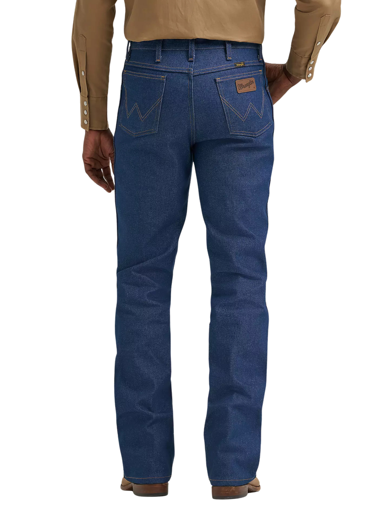 Rear view of a person wearing blue denim jeans with a tan long-sleeve button-up shirt and brown shoes, shown against a plain white background.
