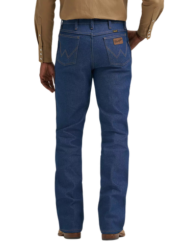 Rear view of a person wearing blue denim jeans with a tan long-sleeve button-up shirt and brown shoes, shown against a plain white background.