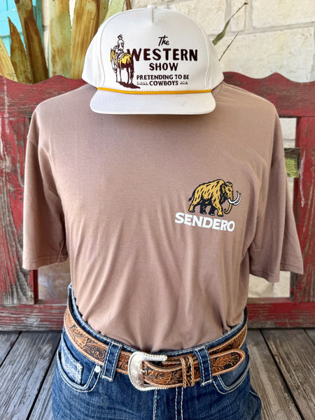 Men's tan mocha Sendero Provisions Co. Mammoth short sleeve tee with gold black woolly mammoth chest logo and white SENDERO text, front view styled with jeans and tooled leather belt — Blair's Western Wear Marble Falls TX