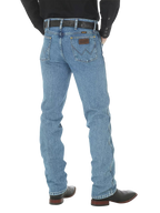 Men's slim fit Cowboy Cut blue jean with Wrangler patch, boot-cut leg opening, and light wash indigo denim — Blair's Western Wear Marble Falls TX