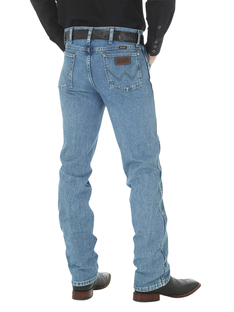 Men's slim fit Cowboy Cut blue jean with Wrangler patch, boot-cut leg opening, and light wash indigo denim — Blair's Western Wear Marble Falls TX
