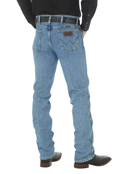 Men's slim fit Cowboy Cut blue jean with Wrangler patch, boot-cut leg opening, and light wash indigo denim — Blair's Western Wear Marble Falls TX