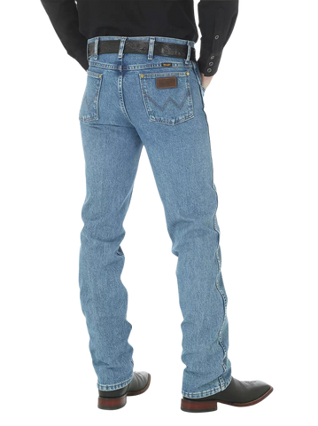Men's slim fit Cowboy Cut blue jean with Wrangler patch, boot-cut leg opening, and light wash indigo denim — Blair's Western Wear Marble Falls TX