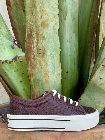 Full side profile — dark brown floral scroll tooled leather, white laces, chunky white platform with black stripe