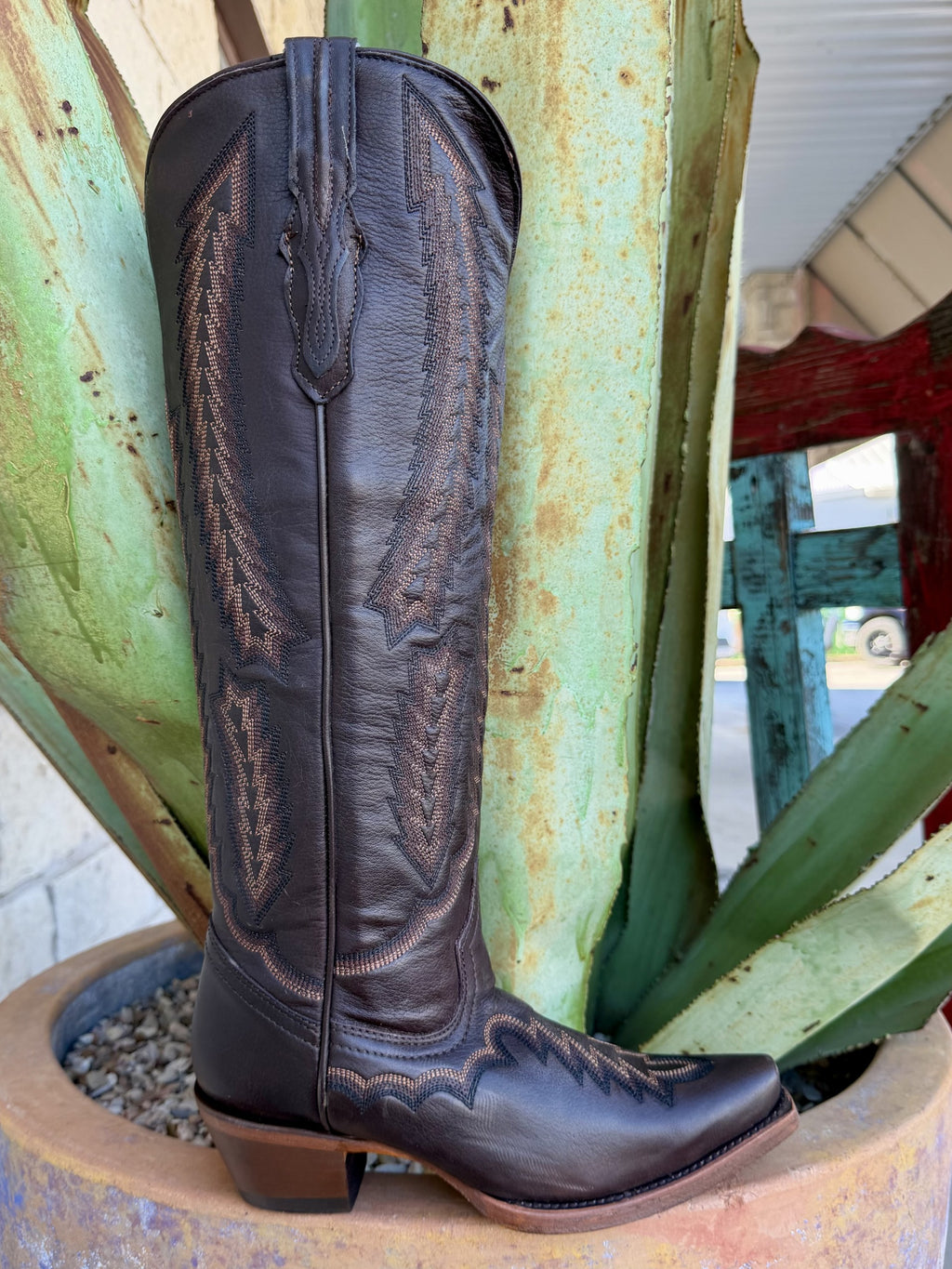  Side view of women's dark chocolate tall Western boot with decorative stitching, tapered toe and brown heel — Blair's Western Wear Marble Falls TX