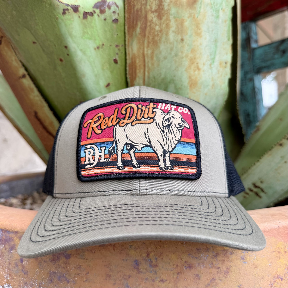 Olive cap with colorful rectangular Brahman cattle patch, black edging and dark bill stitching — Blair's Western Wear Marble Falls TX