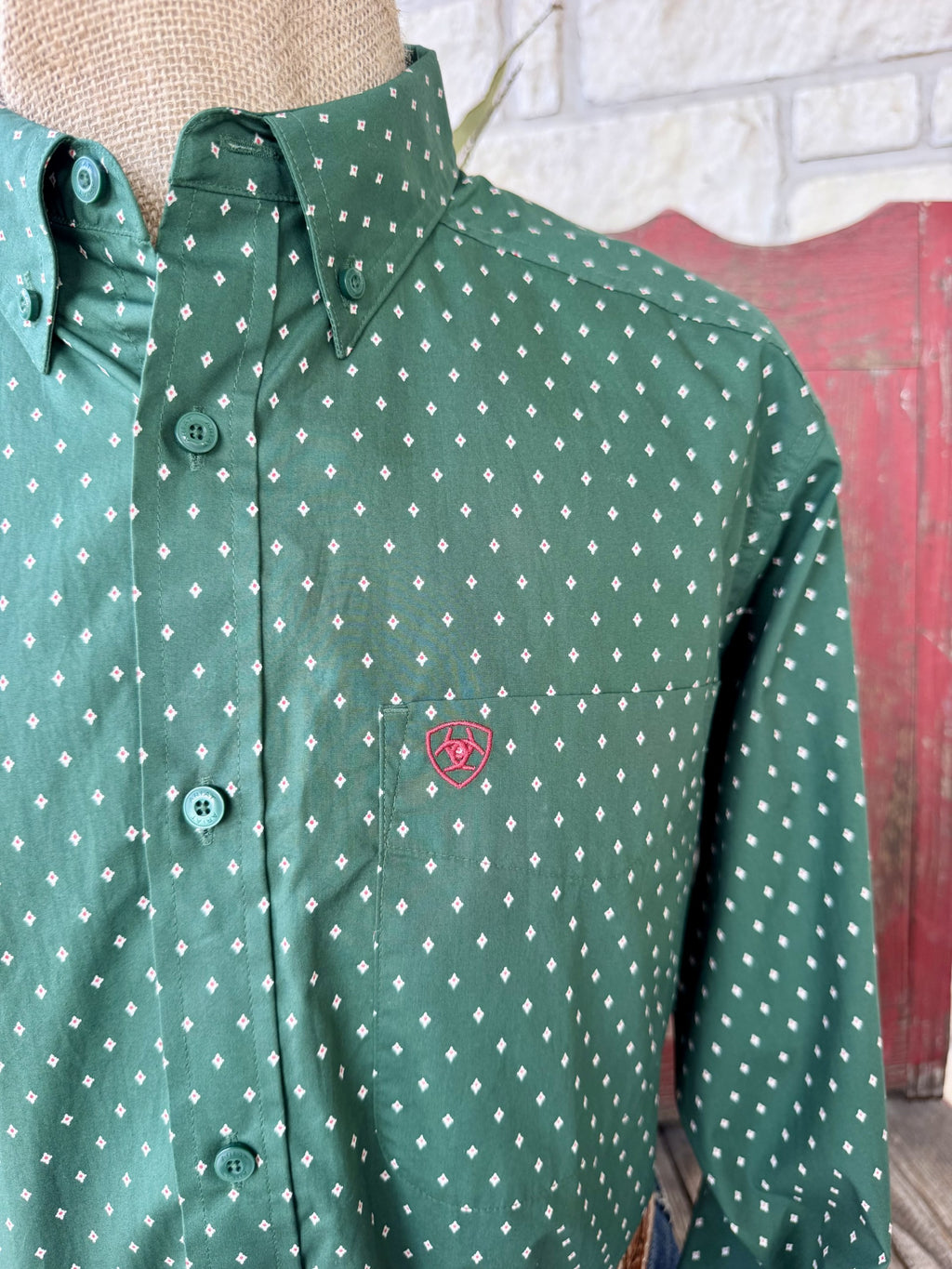 Men's hunter green long sleeve shirt with small white and pink diamond print, button-down collar, green buttons, and chest pocket with pink embroidered logo — Blair's Western Wear Marble Falls TX