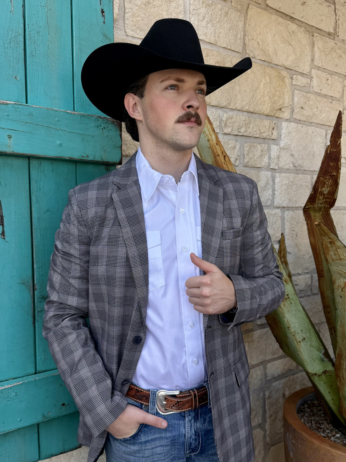 Men's black and white small-plaid sport coat with notch lapels, dark front buttons, welt chest pocket, lower flap pockets, and long sleeves — Blair's Western Wear Marble Falls TX
