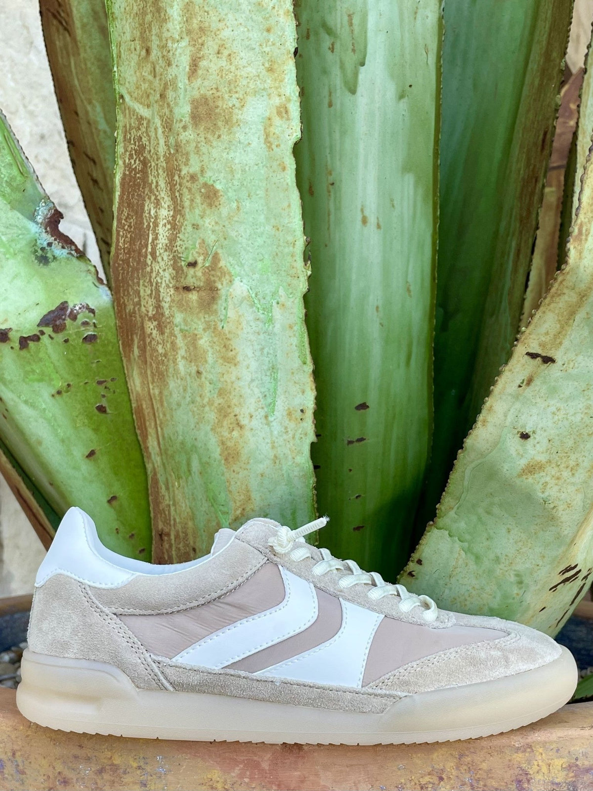 Women's cream and off-white distressed suede low-top retro sneaker with white leather chevron side panel and stripe, white flat laces, white leather collar, and cream translucent gum outsole — Blair's Western Wear Marble Falls TX