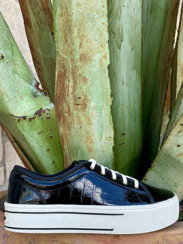 Full side profile — glossy black croc upper, white laces, chunky white platform with black stripe