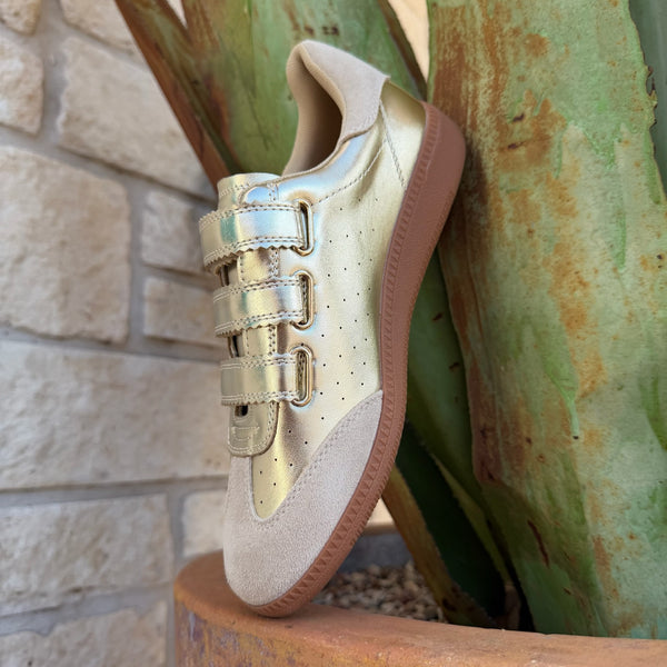 Women's metallic gold low-top sneaker with beige suede panels, velcro closure, and chunky gum sole — Blair's Western Wear Marble Falls TX
