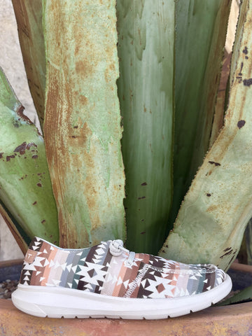 Done! First image alt text added:

Alt: Women's natural brown sage teal and blush Aztec-inspired geometric print textile moc-toe slip-on with light grey rope lace and knot toggle and white FLX Foam EVA outsole, styled against agave plant — Blair's Western Wear Marble Falls