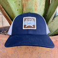 Navy structured kids trucker cap with white mesh back and square Cinch globe and laurel crest woven patch