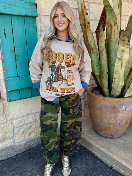 Women's camo barrel crop jean flap back pocket with Risen button hardware close-up — Blair's Western Wear Marble Falls TX