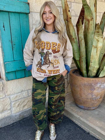 Women's camo barrel crop jean flap back pocket with Risen button hardware close-up — Blair's Western Wear Marble Falls TX