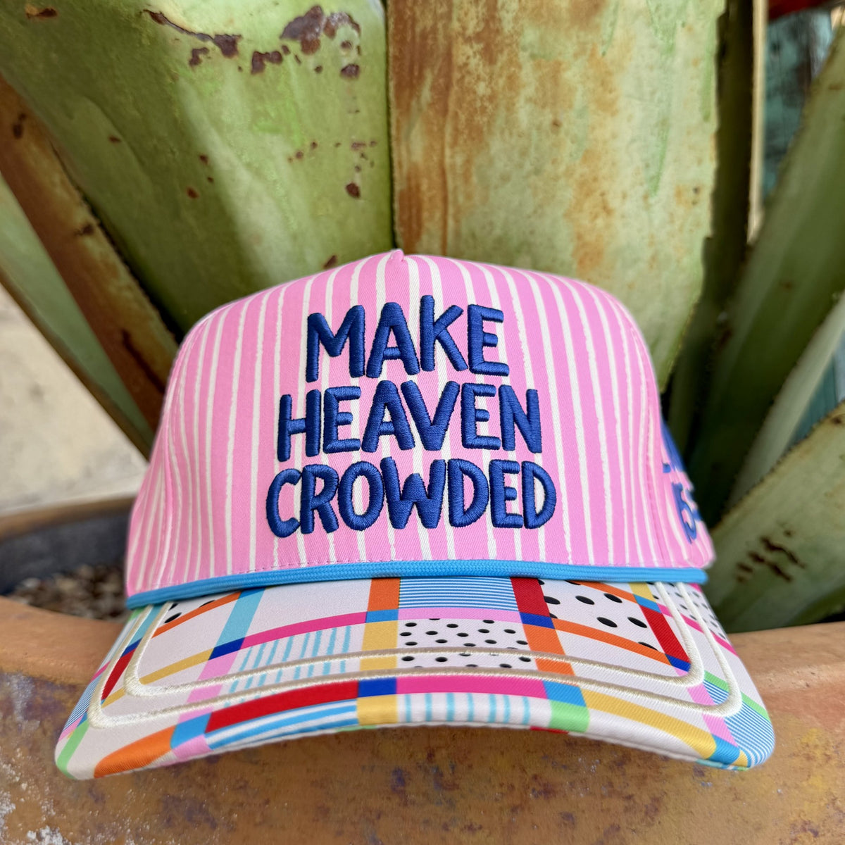  Pink-and-white striped cap with blue “Make Heaven Crowded” embroidery and a curved multicolor geometric-print brim — Blair's Western Wear Marble Falls TX