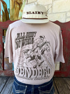 Men's tan Sendero Provisions Co. All Giddy No Whoa short sleeve tee with chocolate cowboy on horseback back graphic and Sendero Provisions Company banner, back view — Blair's Western Wear Marble Falls TX