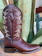 Close-up of cognac boot ankle with cream vine-and-leaf embroidery, dark piping and brown walking heel — Blair's Western Wear Marble Falls TX