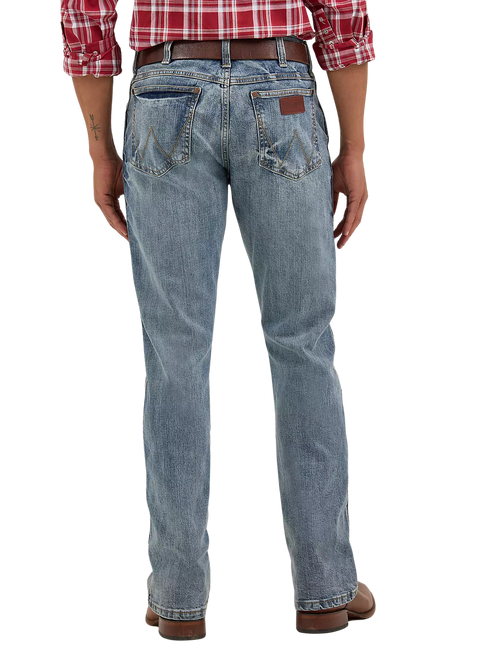 Men's slim bootcut Wrangler Retro blue jean with W-stitch back pockets, rope logo leather patch, and boot-friendly leg opening — Blair's Western Wear Marble Falls TX