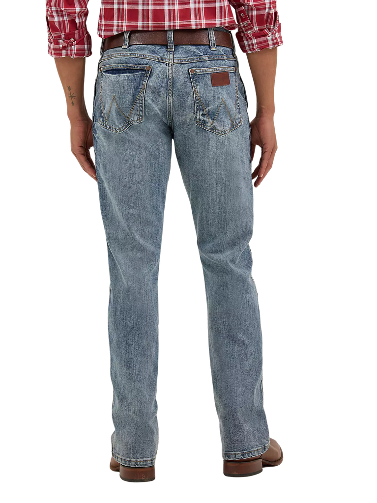 Men's slim bootcut Wrangler Retro blue jean with W-stitch back pockets, rope logo leather patch, and boot-friendly leg opening — Blair's Western Wear Marble Falls TX