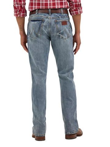 Men's slim bootcut Wrangler Retro blue jean with W-stitch back pockets, rope logo leather patch, and boot-friendly leg opening — Blair's Western Wear Marble Falls TX