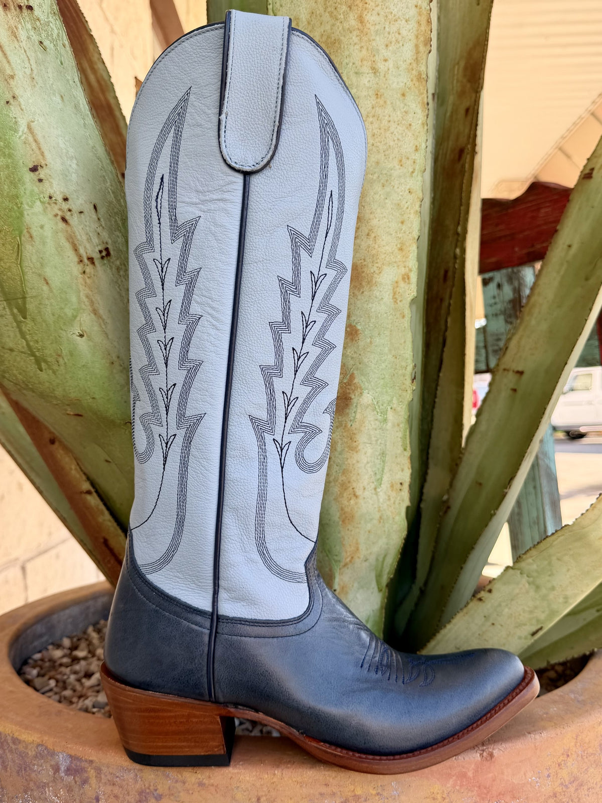 Women's tall Western boot with light blue shaft, dark blue foot, contrasting decorative stitching, pull tab, brown heel, and brown sole edge — Blair's Western Wear Marble Falls TX
