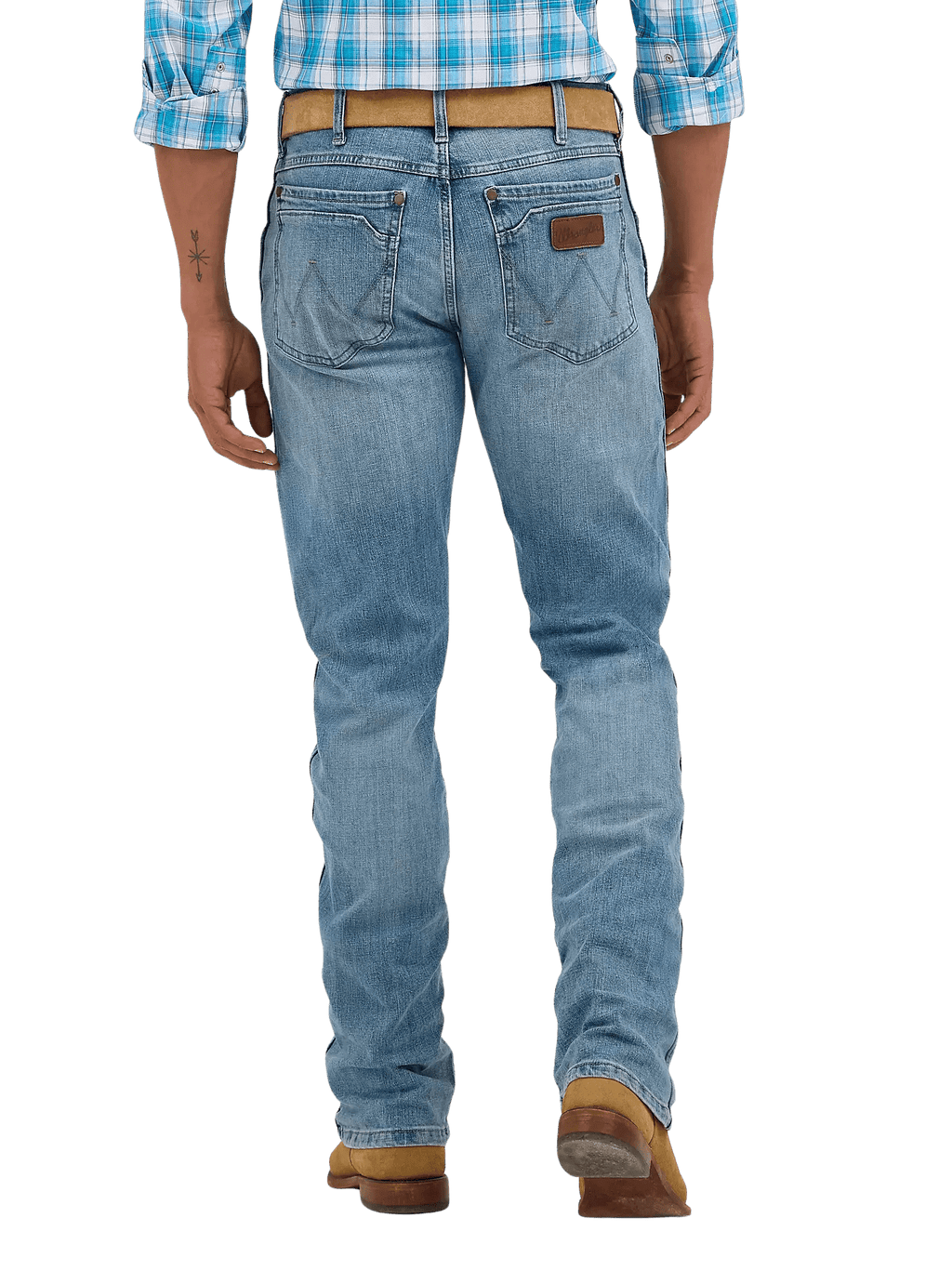 Rear view of a person wearing light blue denim jeans with a brown leather patch on the back pocket, a tan belt, and brown boots against a white studio background.