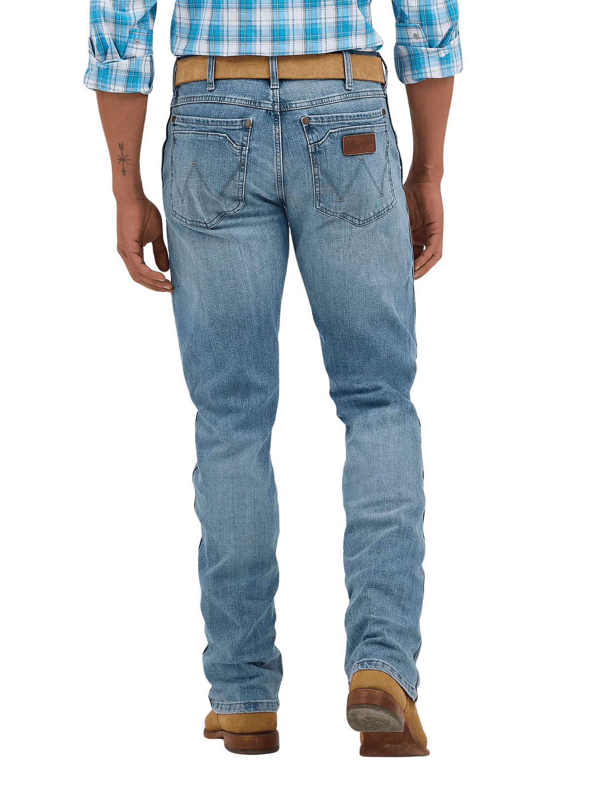 Rear view of a person wearing light blue denim jeans with a brown leather patch on the back pocket, a tan belt, and brown boots against a white studio background.