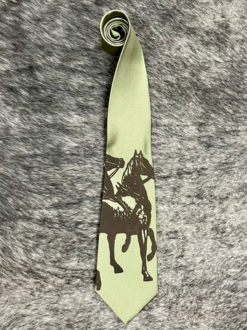 Men's sage green satin necktie with tonal dark brown rearing horse and rider silhouette print, smooth finish, standard width pointed tip — Blair's Western Wear Marble Falls TX