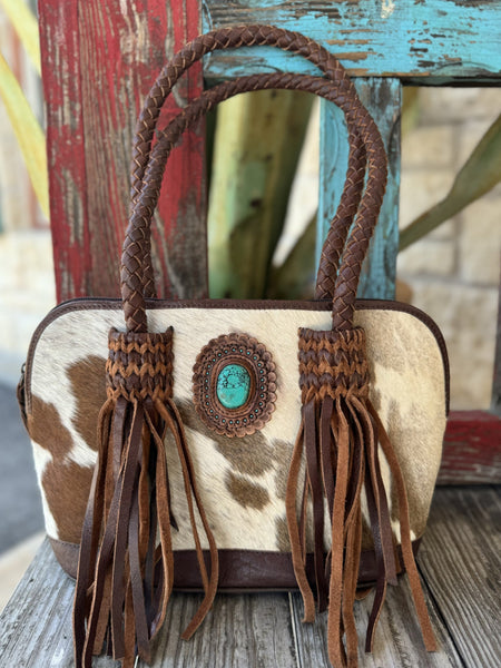 Ladies cowhide and leather fringe handbag in brown and white, with braided straps and zippered closure – ADBGM333B. Available at Blair's Western Wear, Marble Falls, TX.