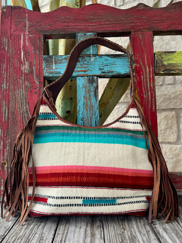 American Darling purse blanket fringe purse in multicolor with genuine leather body, woven blanket front panel, and hand-tooled sunflower leather strap with fringe detailing - ADBG803AC. Available at Blair's Western Wear, Marble Falls, TX.