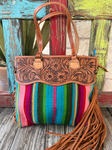 American Darling Serape Fringe Tote Bag in multicolor, hand-tooled leather panels for lasting structure, with vibrant woven serape fabric for bold Western style – ADBGS144SER8. Available at Blair's Western Wear, Marble Falls, TX.