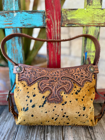 American Darling tool hide purse in tan and brown, genuine hair-on hide front with natural speckled pattern, featuring hand-tooled leather overlay and antique-style stud accents - ADBG713D. Available at Blair's Western Wear, Marble Falls, TX.