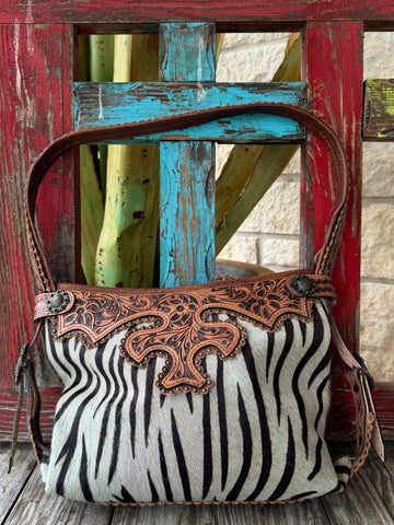 American Darling hide purse with tooled leather in zebra print, crafted with genuine hair-on-hide, with a secure top zipper closure - ADBG713G. Available at Blair's Western Wear, Marble Falls, TX.