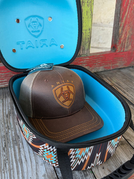Keep your favorite caps safe and travel-ready with the Ariat Cap Carrier A3099897. Designed in a bold brown, black, and turquoise Aztec pattern, this sturdy case holds 4–6 caps without losing their shape. Perfect for rodeos, road trips, or everyday storage—stylish, practical, and built the Ariat way.Available at BLAIR'S Western Wear located in Marble Falls TX.