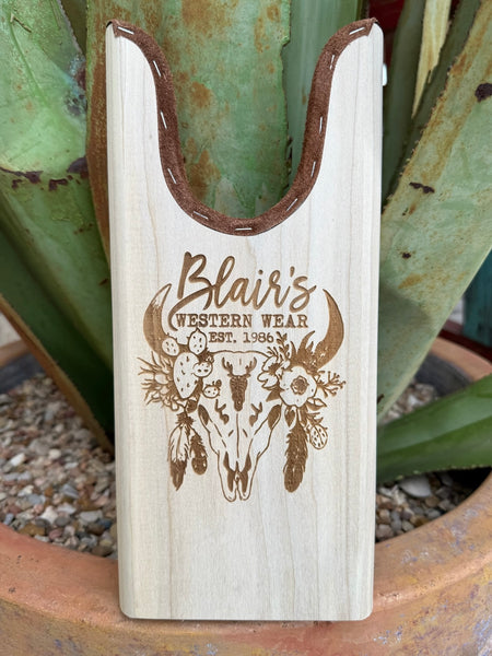 Blair’s Boot Jack - JACK SKULL -  Expertly crafted from durable natural wood and lined with soft suede for added protection, this piece features an elegant skull floral engraving for a refined Western touch. Designed for daily use, it offers both practicality and timeless style for any boot owner. Available at BLAIR'S Western Wear located in Marble Falls TX.