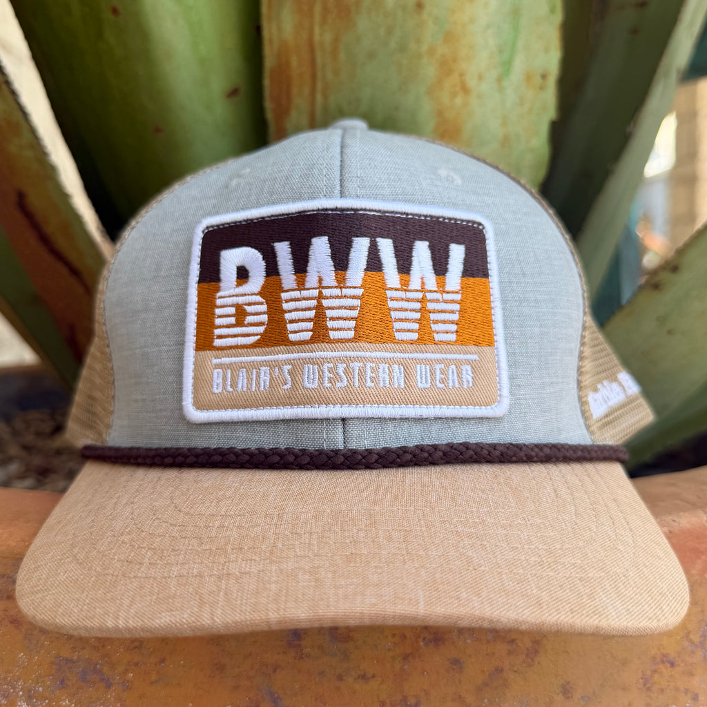 A light gray and tan trucker hat with a brown and orange embroidered patch reading 'BWW BLAIR'S WESTERN WEAR' on the front