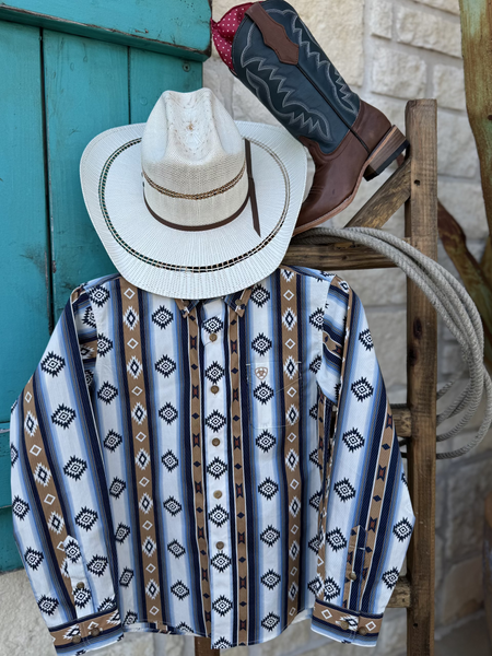 Boy's Long Sleeve Ariat Aztec Shirt - 10062394. This shirt features a blue, navy, tan, brown and white aztec pattern and it has a pocket on the left side of the chest. Available at Blair's Western Wear located in Marble Falls. TX