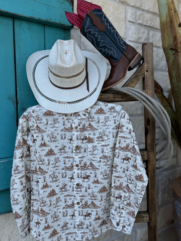 Boy's Long Sleeve Ariat Western Desert Shirt - 10062392. This white button down shirt features a fun western desert graphic with cowboys riding horses in the wild and it also has a pocket on the left side of the chest. Available at Blair's Western Wear located in Marble Falls. TX
