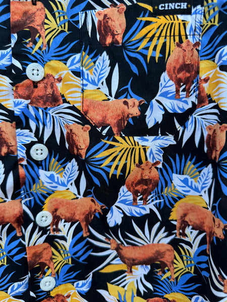 Close up of Boy's Short Sleeve Cinch Shirt (MTW7170001) . It features a tropical black, blue,white and orange design along with cattle graphics all over. Available at Blair's Western Wear located in Marble Falls, TX. 
