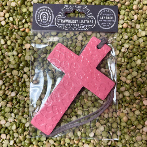 Callahan leather cross air freshener in pink leopard, made from long-lasting fragrance-infused leather, with a sturdy suede hanging string for easy placement – AFCROSSPNKSLCHT. Available at Blair's Western Wear, Marble Falls, TX.