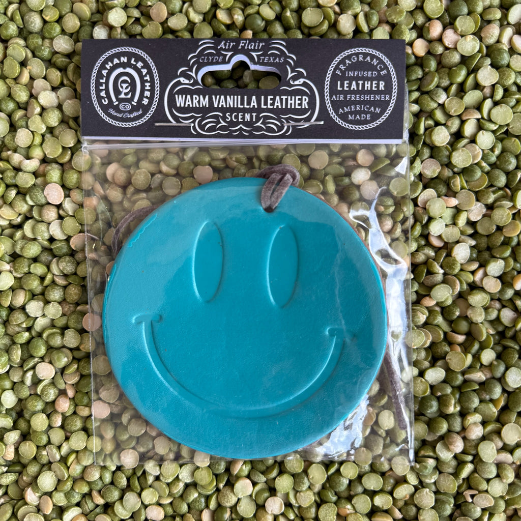 Callahan Leather Air Flair Smiley Face Air Freshener in Turquoise, handmade full-grain leather infused with warm vanilla scent and easy-hang strap – AFRSMILTRQVL. Available at Blair's Western Wear, Marble Falls, TX.