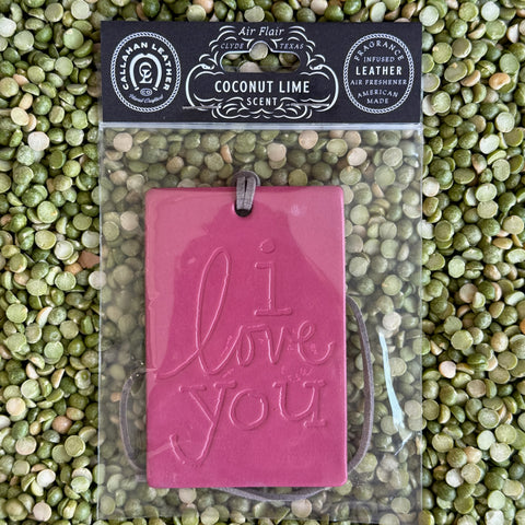 Callahan Leather Air Freshener Coconut Lime "I Love You" in Deep Pink, scented with refreshing coconut lime, with embossed message and leather strap for easy hanging - AFRECILUFCHCL. Available at Blair's Western Wear, Marble Falls, TX.