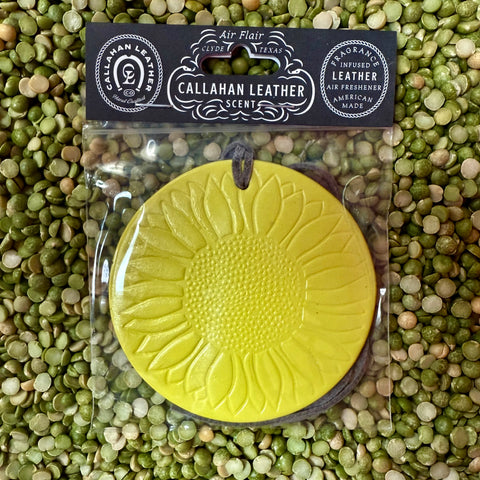 Callahan Leather air freshener yellow sunflower in leather, made from fragrance-infused leather that maintains long-lasting freshness, with a soft suede cord for easy hanging – AFRSFYLLLTH. Available at Blair's Western Wear, Marble Falls, TX.